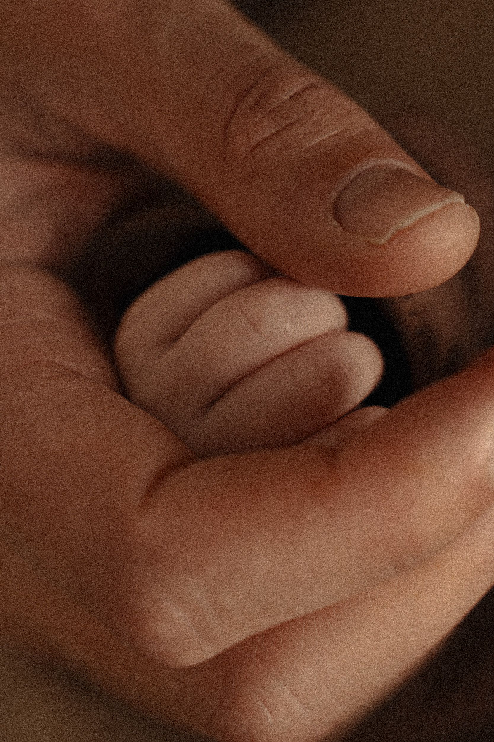 Close-up shot of intertwined hands showing intimacy and connection.