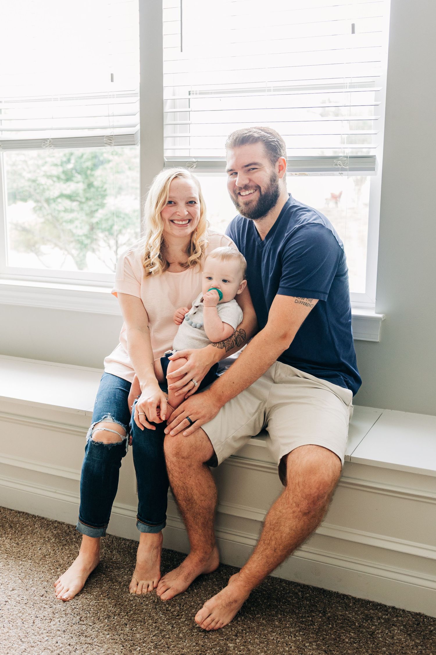 A tender family moment captured in a series of photos showing parents bonding with their newborn baby near a window.