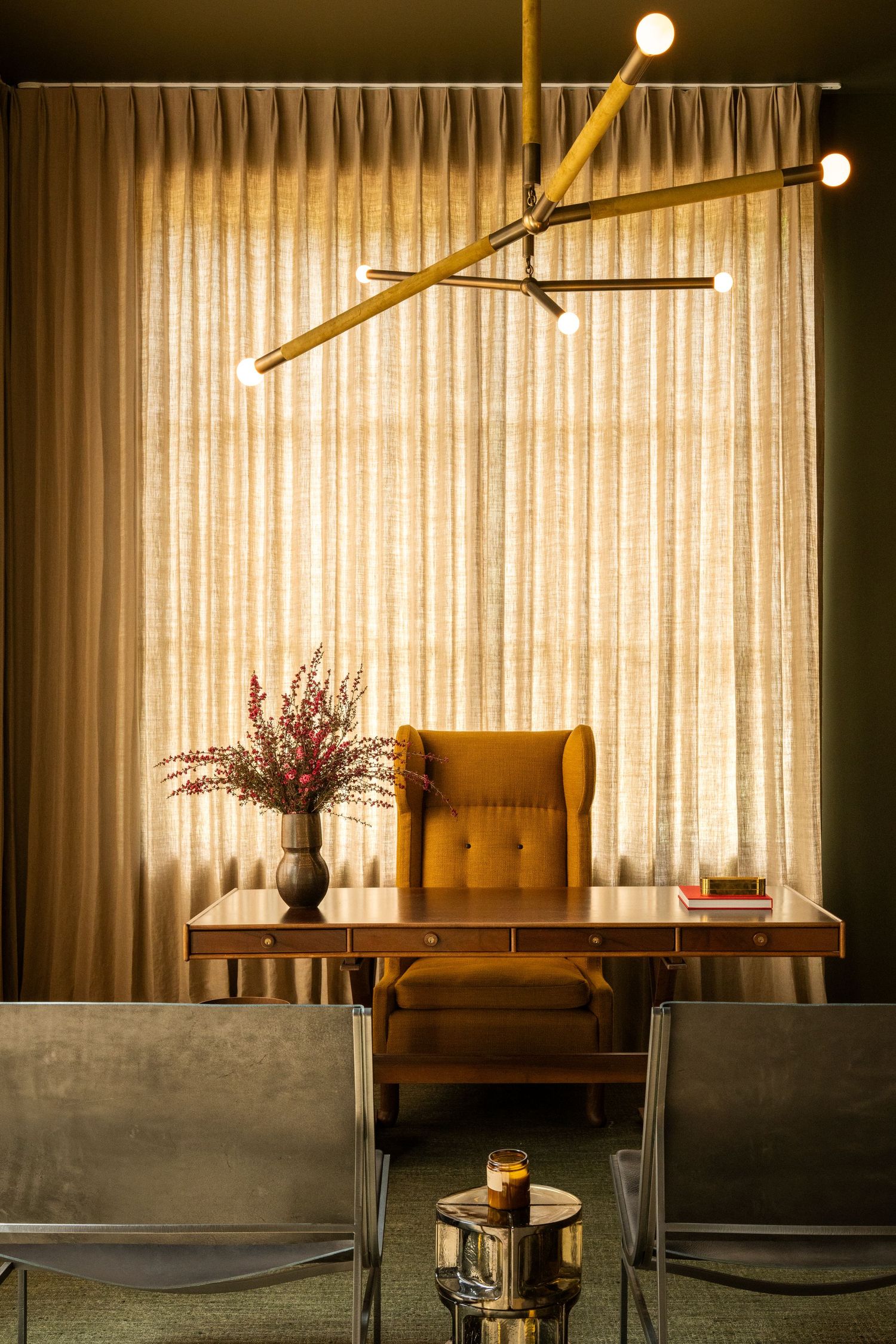 Modern dining room interior with concrete walls, wooden bench seating, and warm lighting creates a cozy atmosphere.