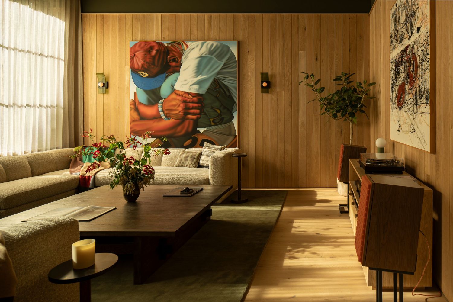 Warm sunlight streams through vertical blinds into a wood-paneled room with retro furniture and decor.