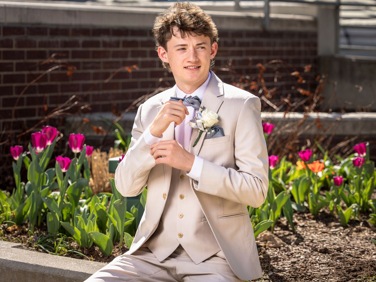 A young man smiles for a portrait prom photo at Fayetteville's Town Center