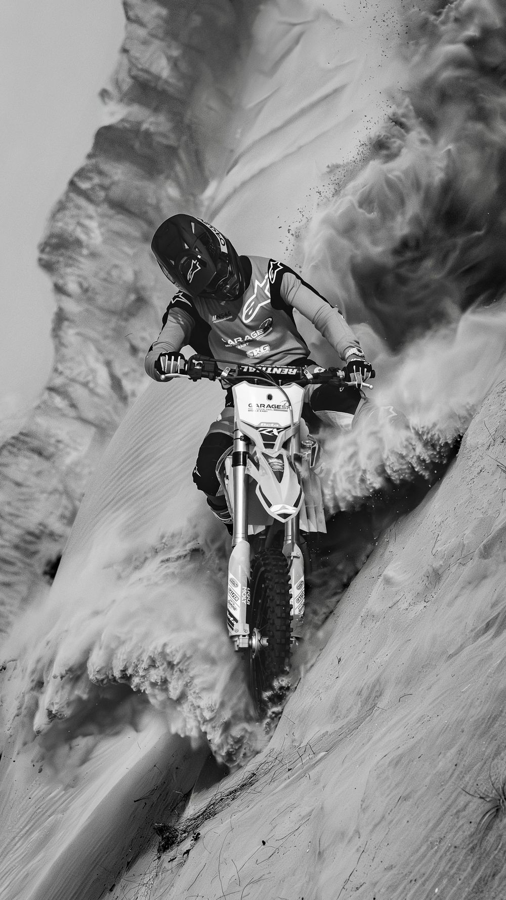 Black and White photo of motocross rider Jarryd Coetzee riding Beta Motorcycle and wearing Alpinestars suit in UAE desert.