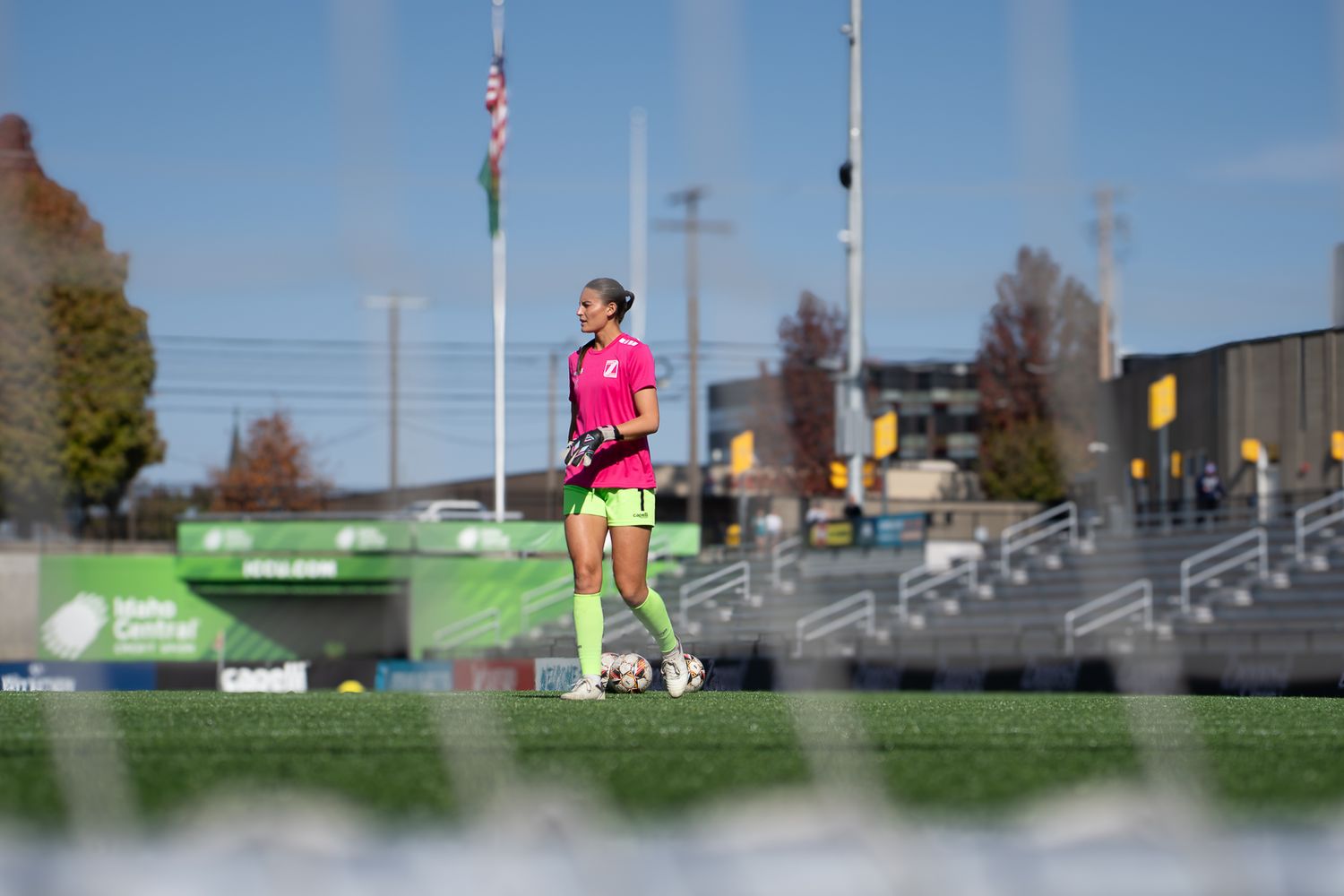 A series of five connected photos showing a person warming up for a soccer game at the stadium with bleachers in the background.