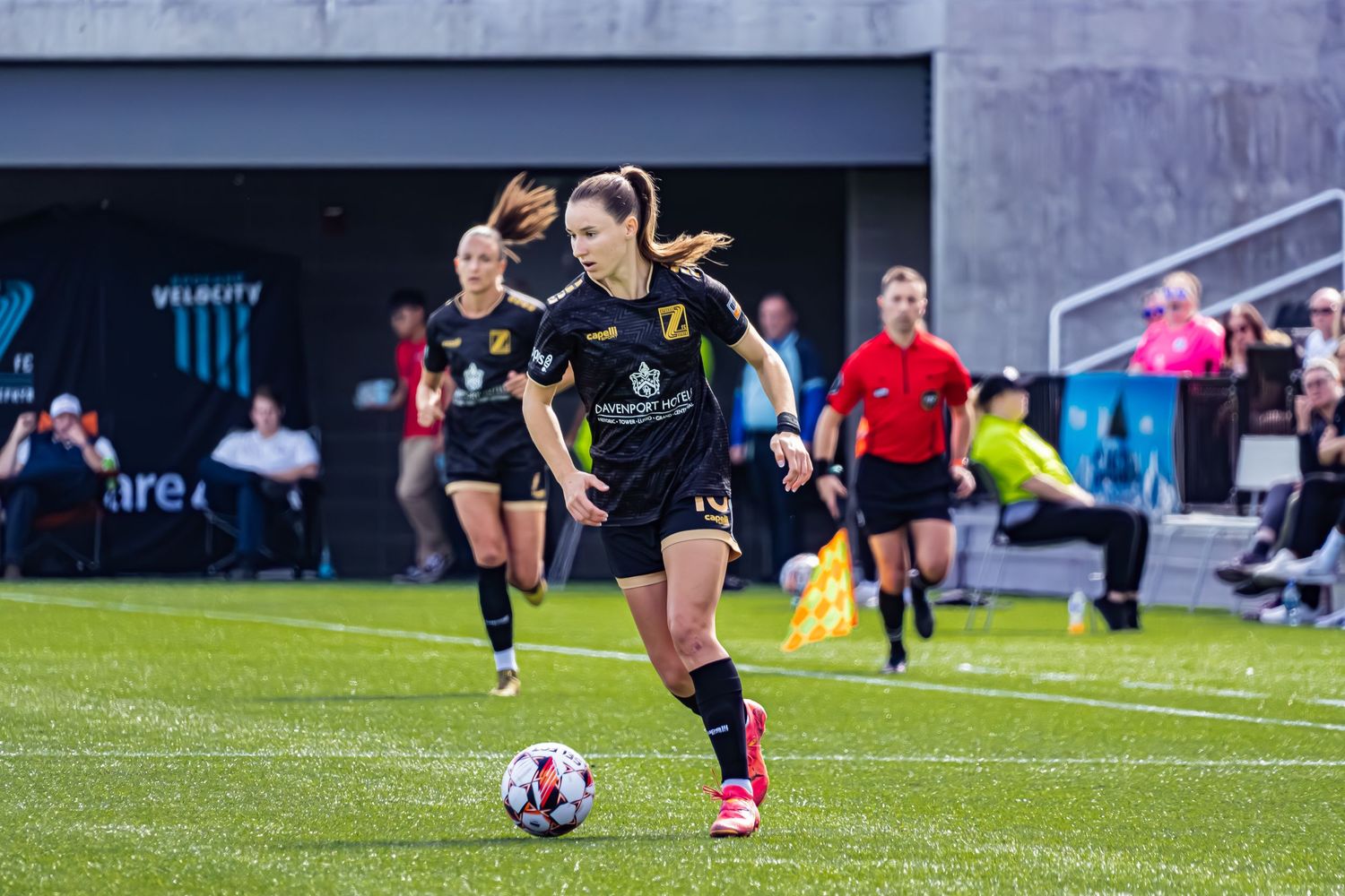 Soccer players practice drills and training exercises on a green turf field during a team workout session.