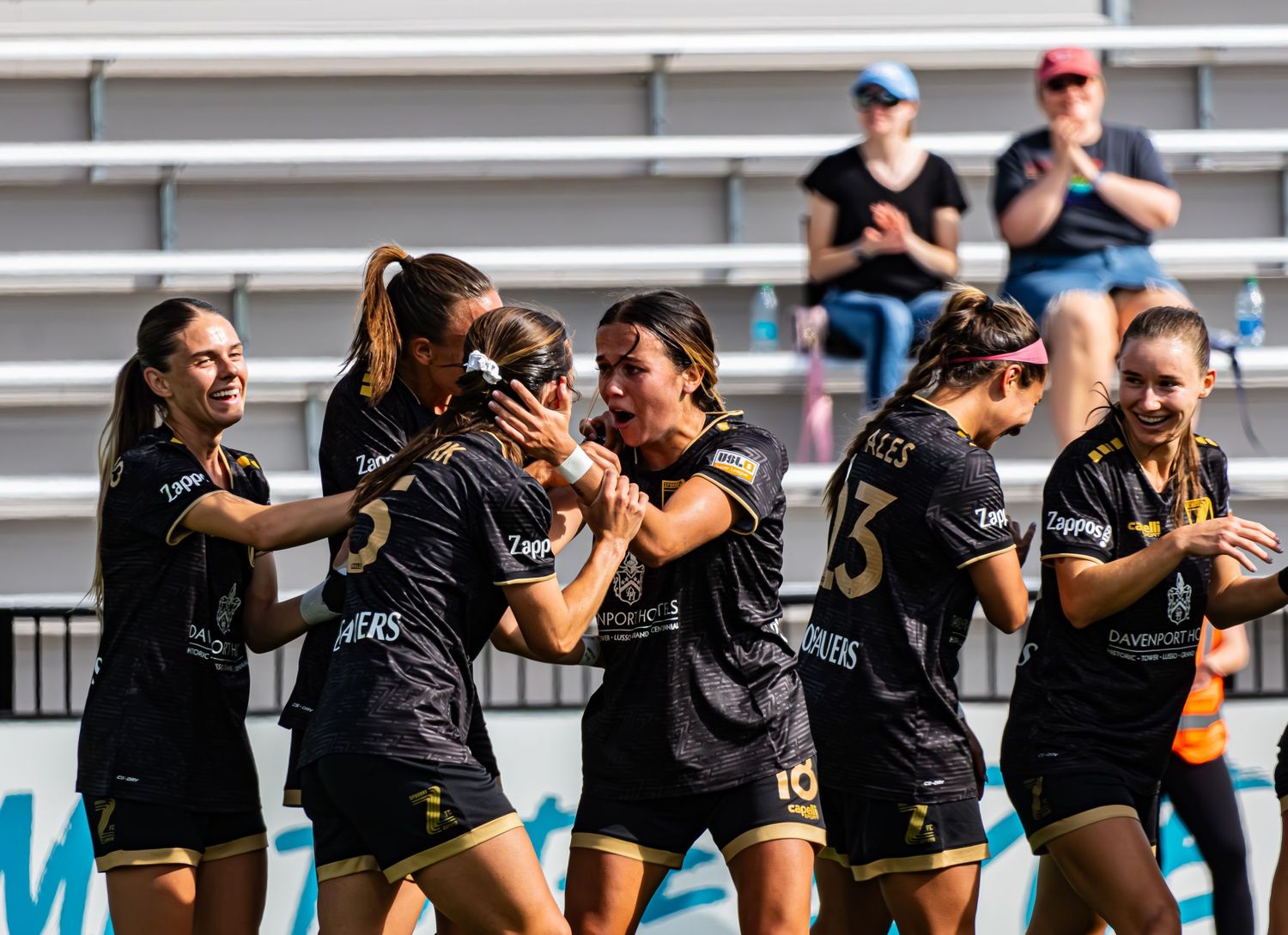 Athletes in black uniforms during a sports event.