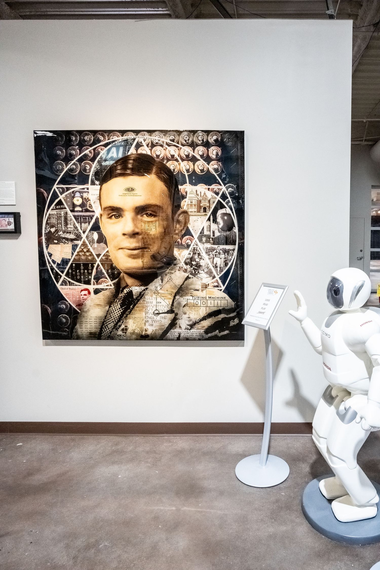 Vintage technological artwork installation with a portrait overlaid with geometric patterns and mathematical formulas.