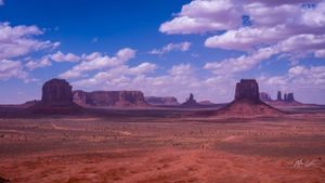 Vast desert landscape with towering red rock formations stretching across Monument Valley.