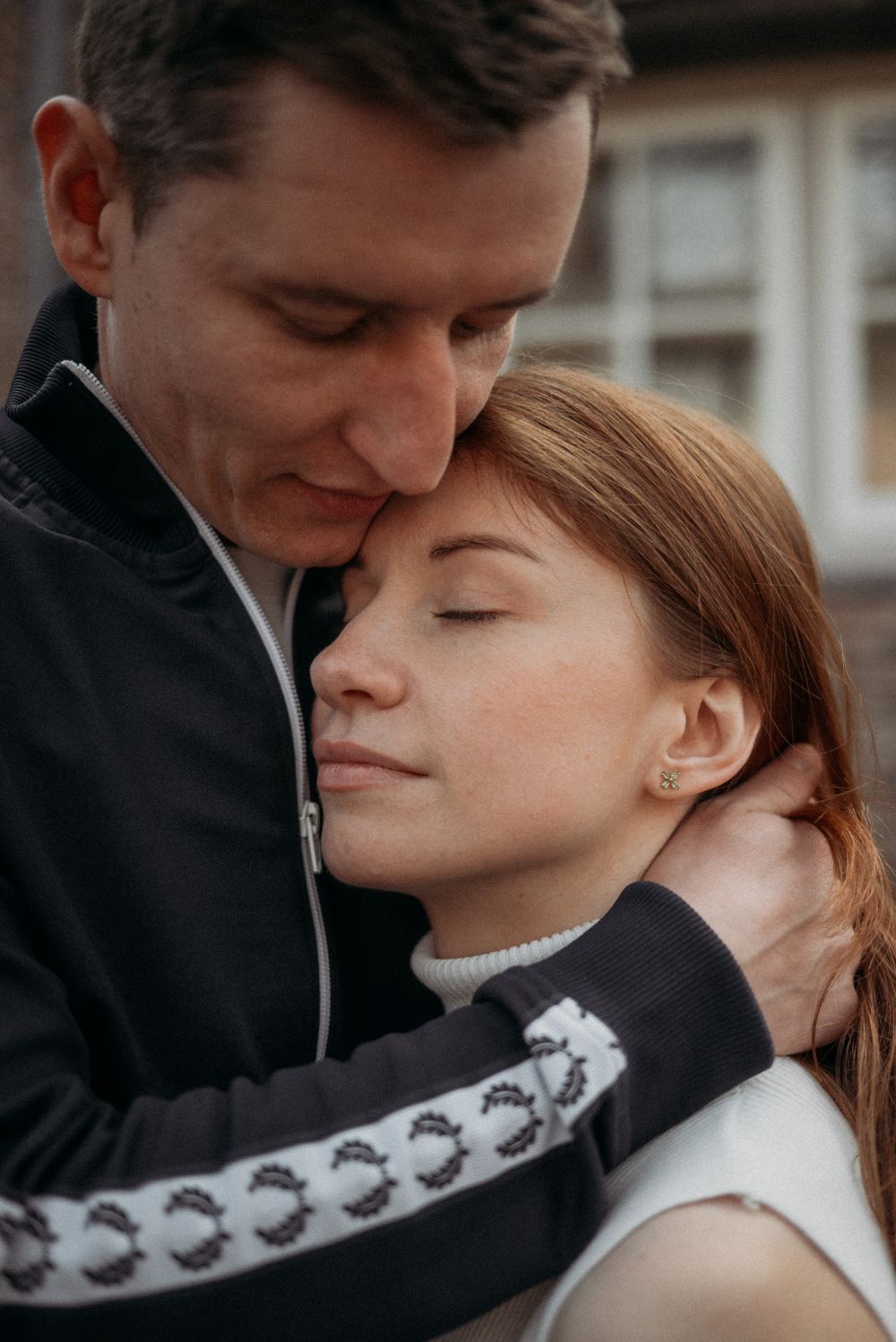 Tender close-up moments captured between a couple wearing black and white clothing.