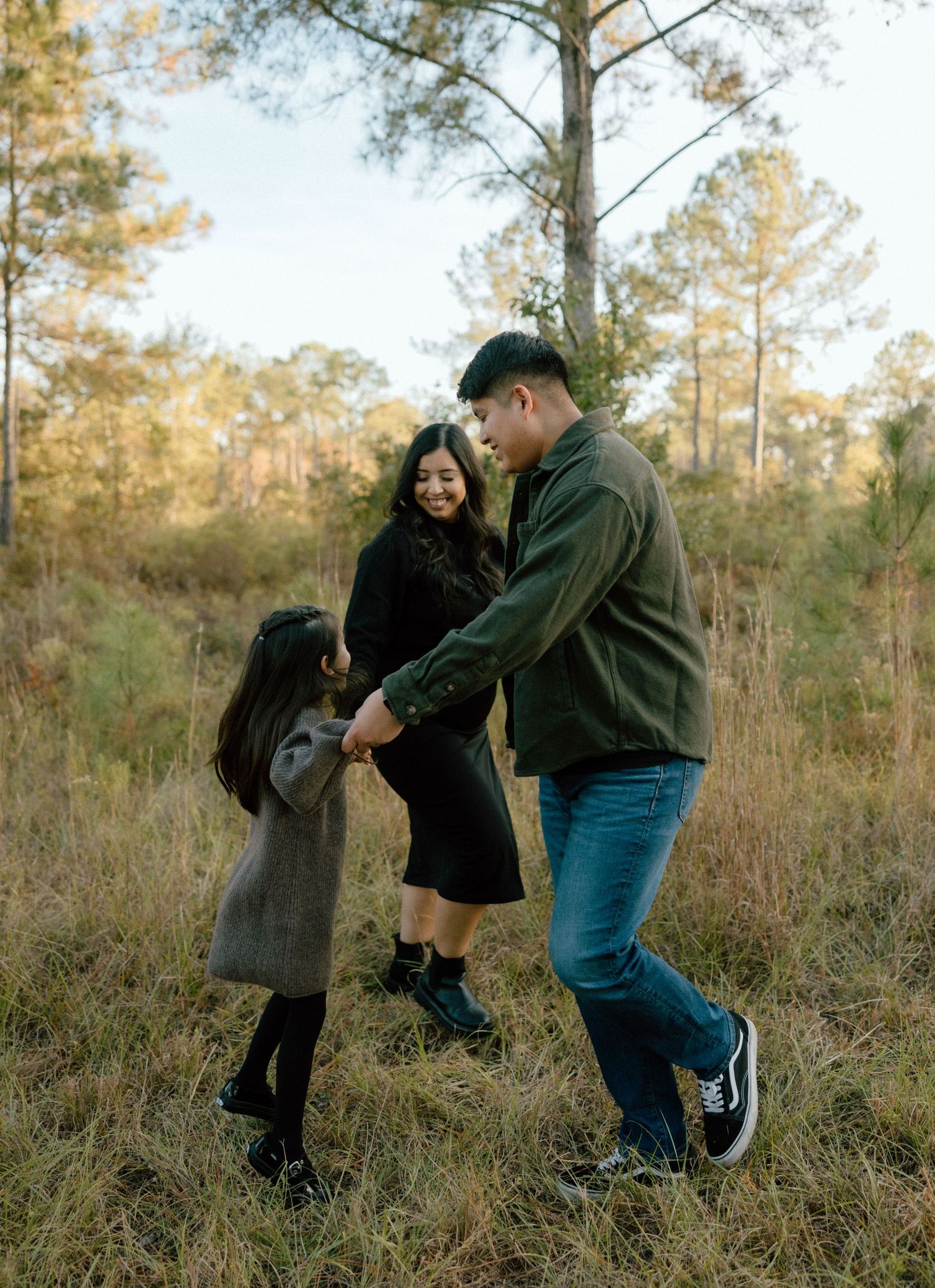 A family shares playful moments together in a pine forest during golden hour, captured in a series of candid and fun shots.