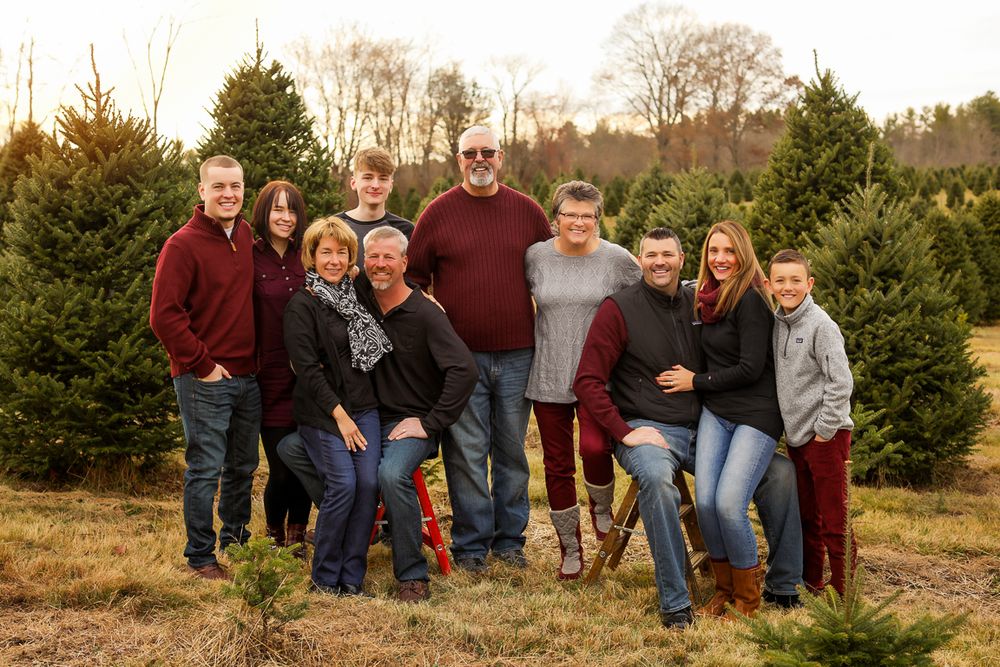 Large family photographed surrounded by Christmas trees in Eliot Maine South Berwick