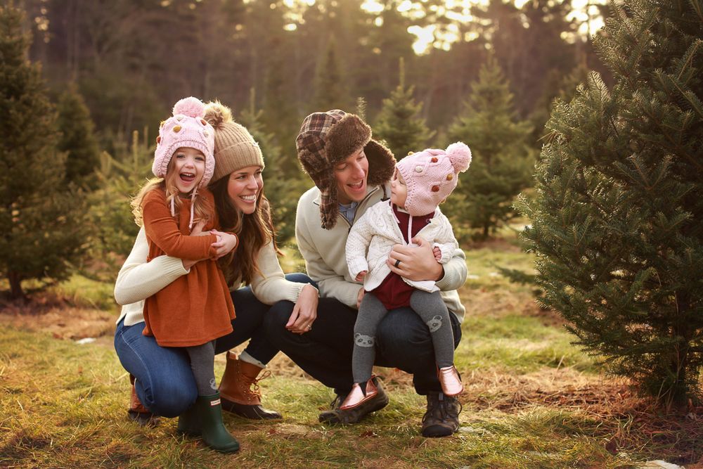 Tree farm in Portsmouth New Hampshire family photographed with hats on in the field