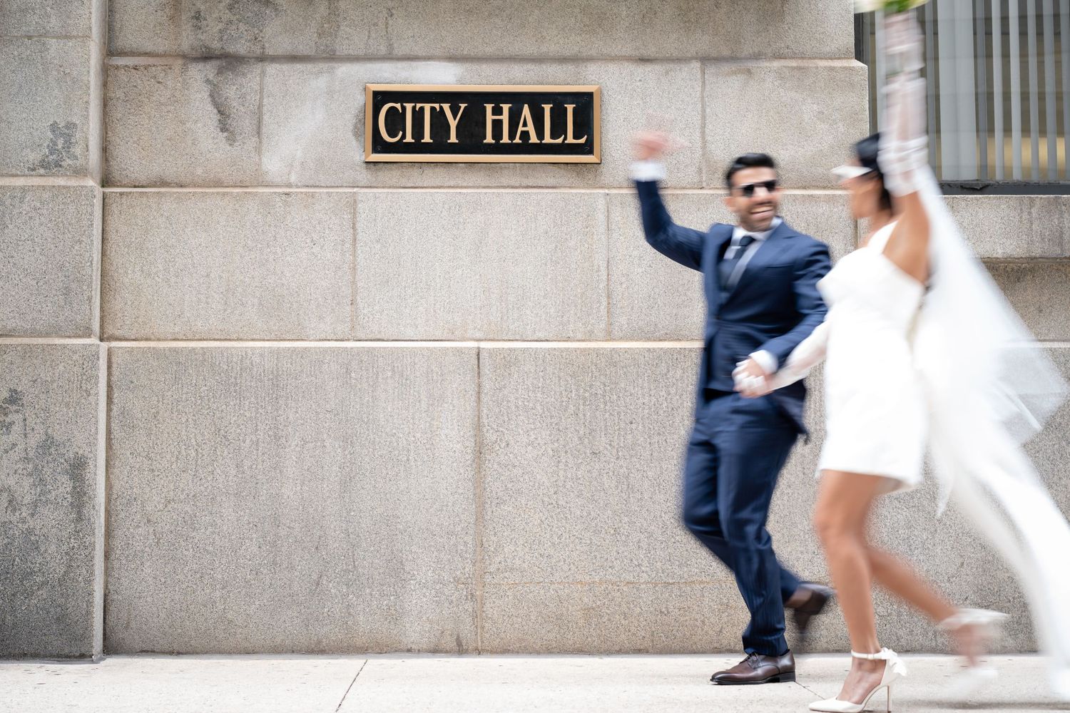 Sequence of couple walking and posing outside City Hall building.