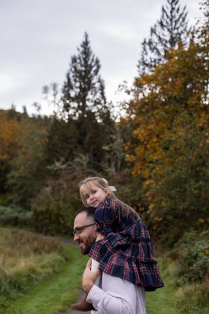 A joyful autumn moment shared on a forest path.