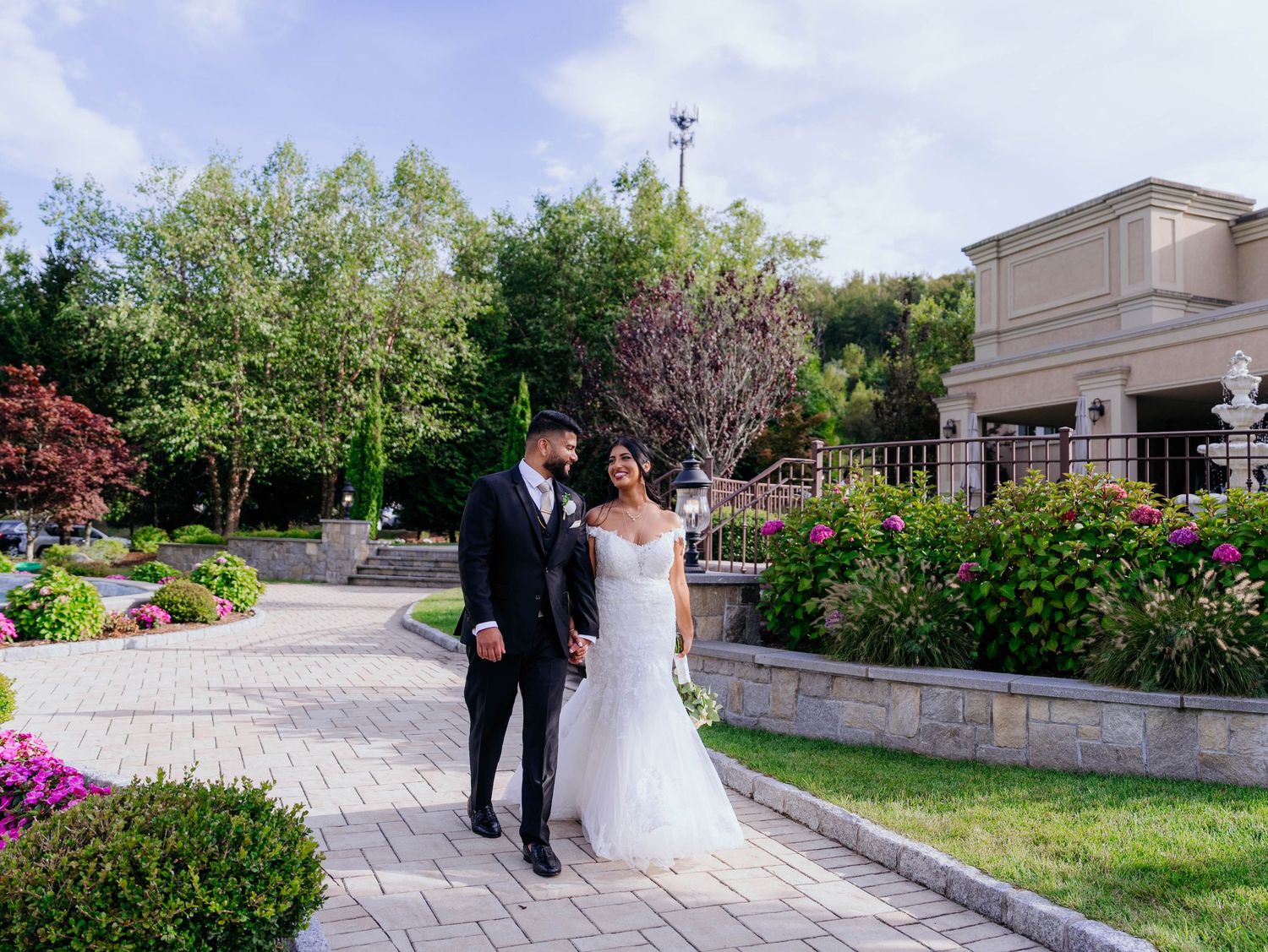 Newlyweds joyfully exit down church steps surrounded by celebrating guests.