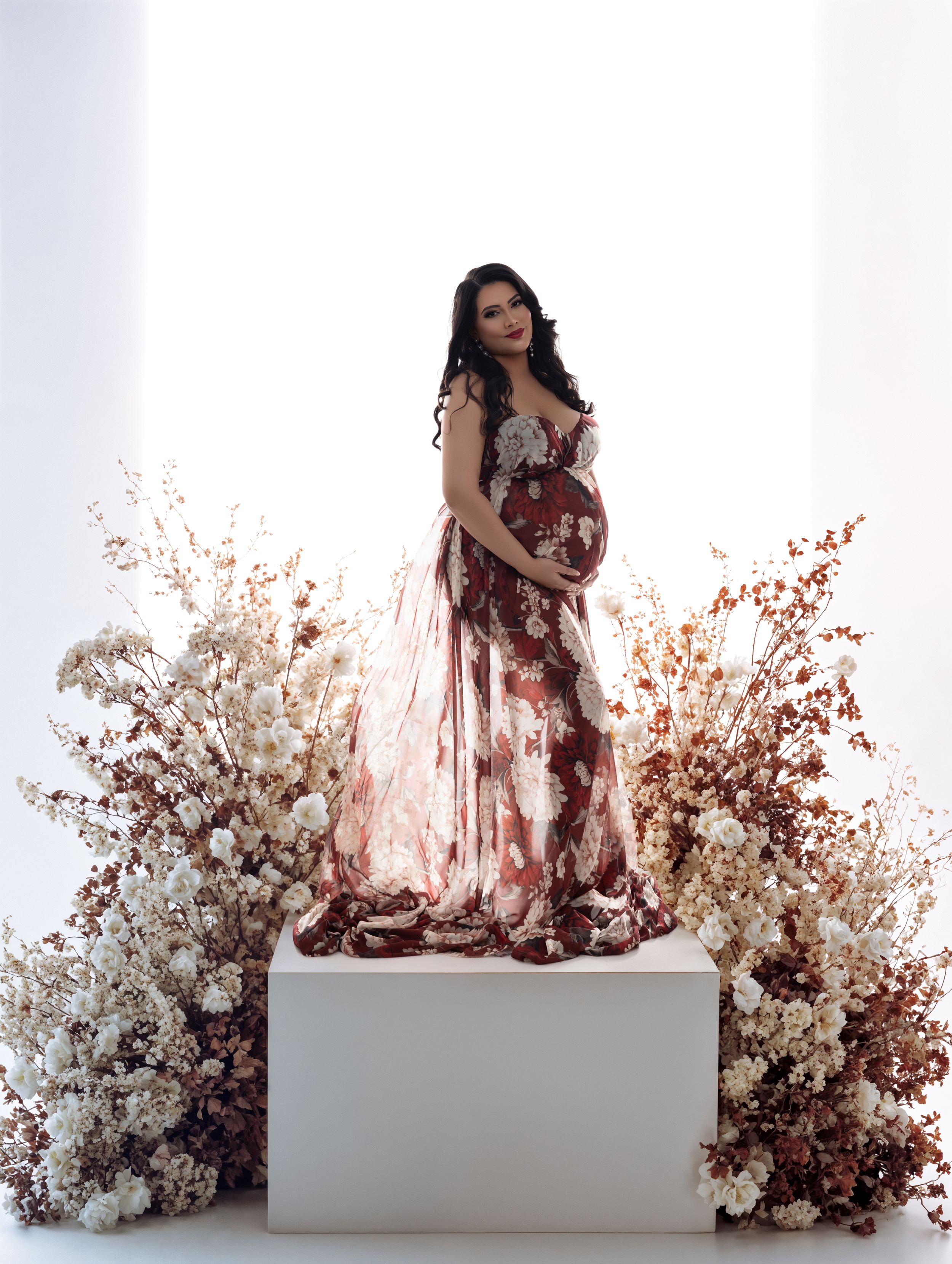 Artistic photo series showing figure in flowing dress against ethereal backdrop of white and red dried flowers.