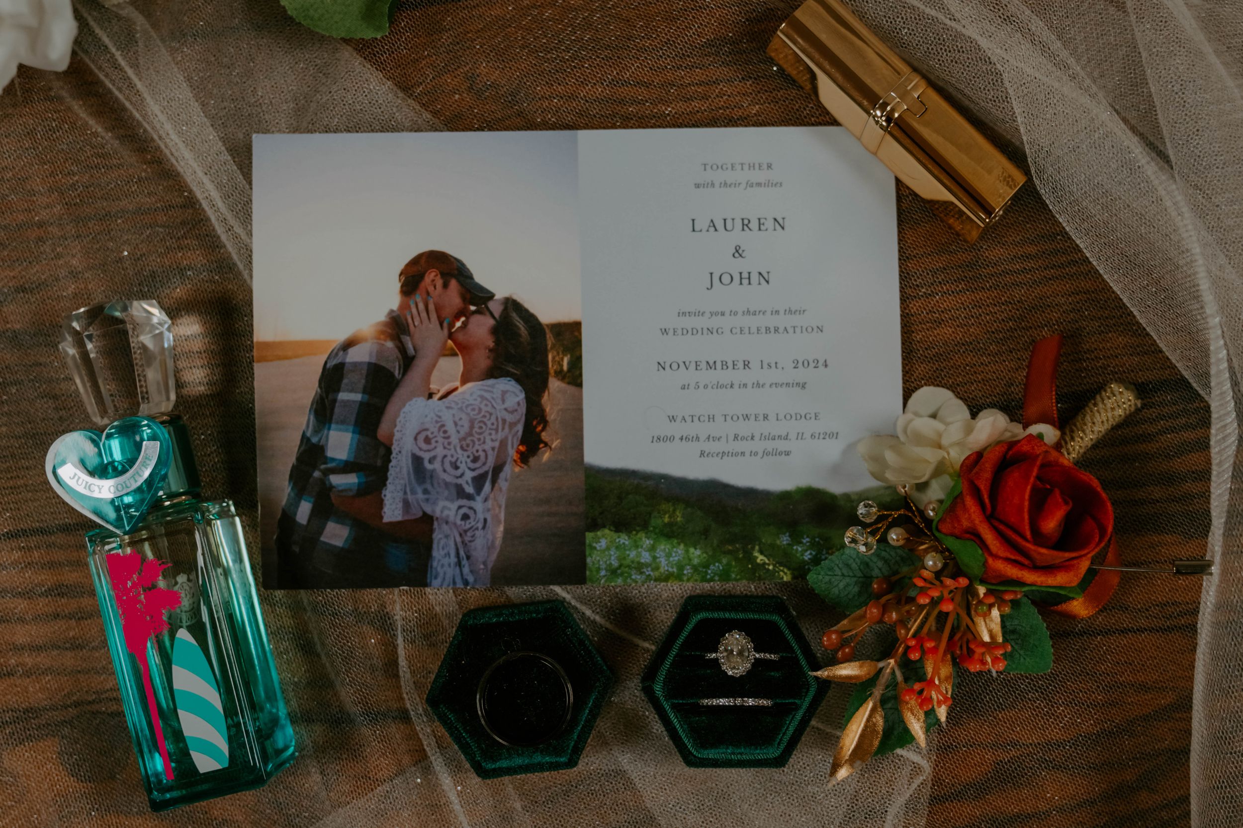 Wedding details including invitations and decorative items arranged on a wooden surface.