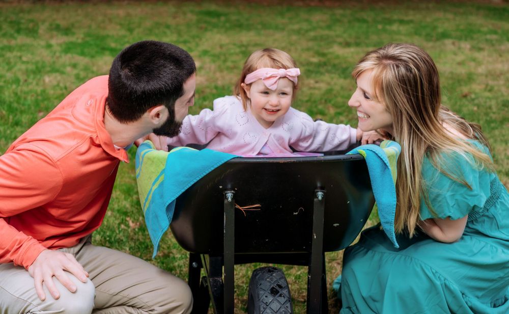 Group relaxing together on a blanket during an outdoor autumn photoshoot.
