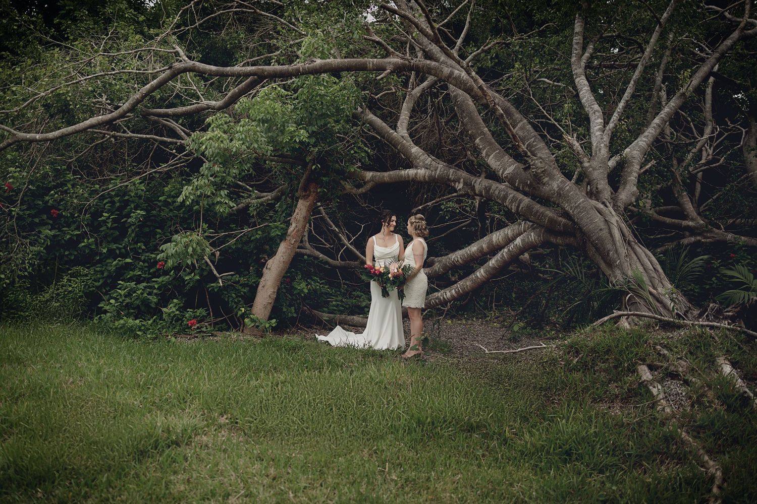 Romantic beach moment between two brides at Dreams Tulum LGBT wedding