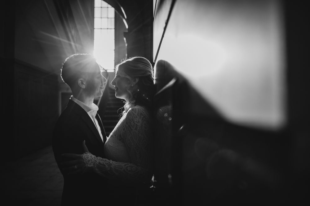 Black and white portraits show silhouettes of a couple in dramatic window lighting.
