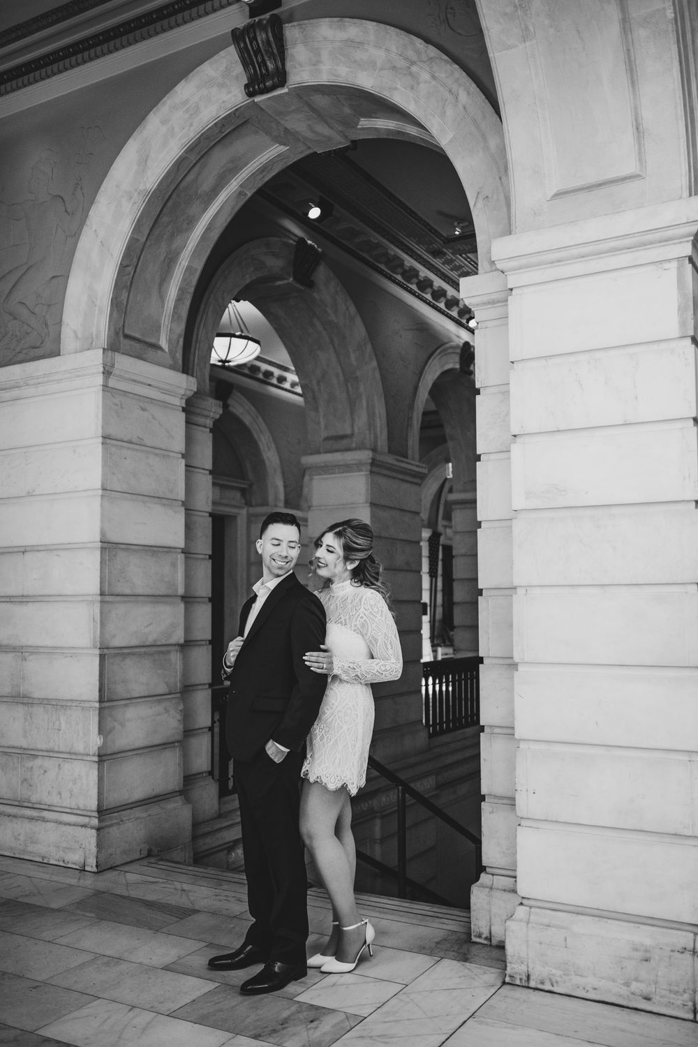 Black and white images show a couple dancing through a historic stone archway.