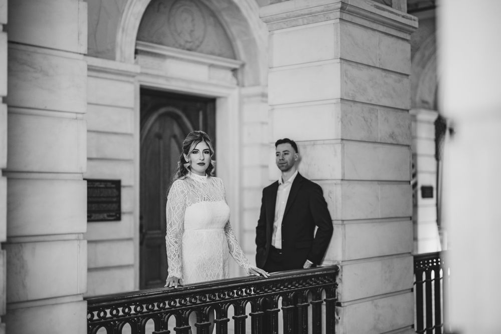 A series of romantic poses captured along a classical colonnade with stone pillars.