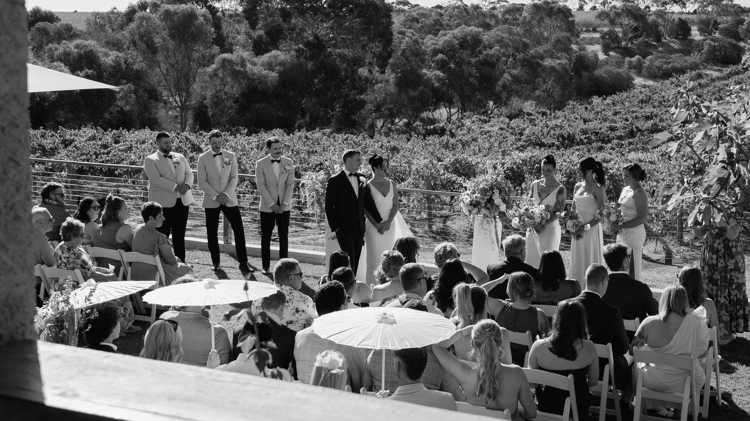 Black and white panoramic photo showing a large outdoor crowd gathering at a public event.