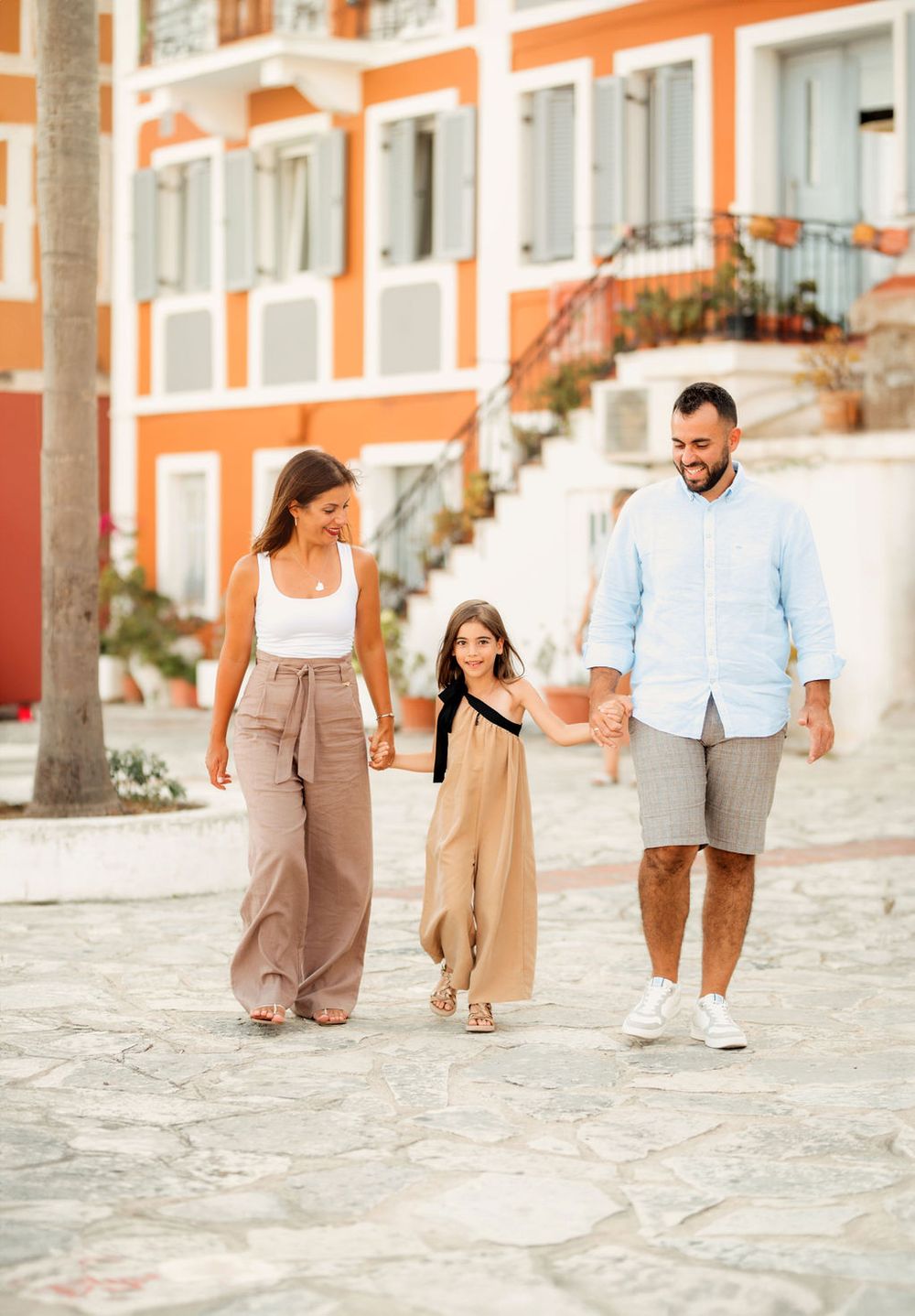 Family taking a casual stroll through charming European town streets.