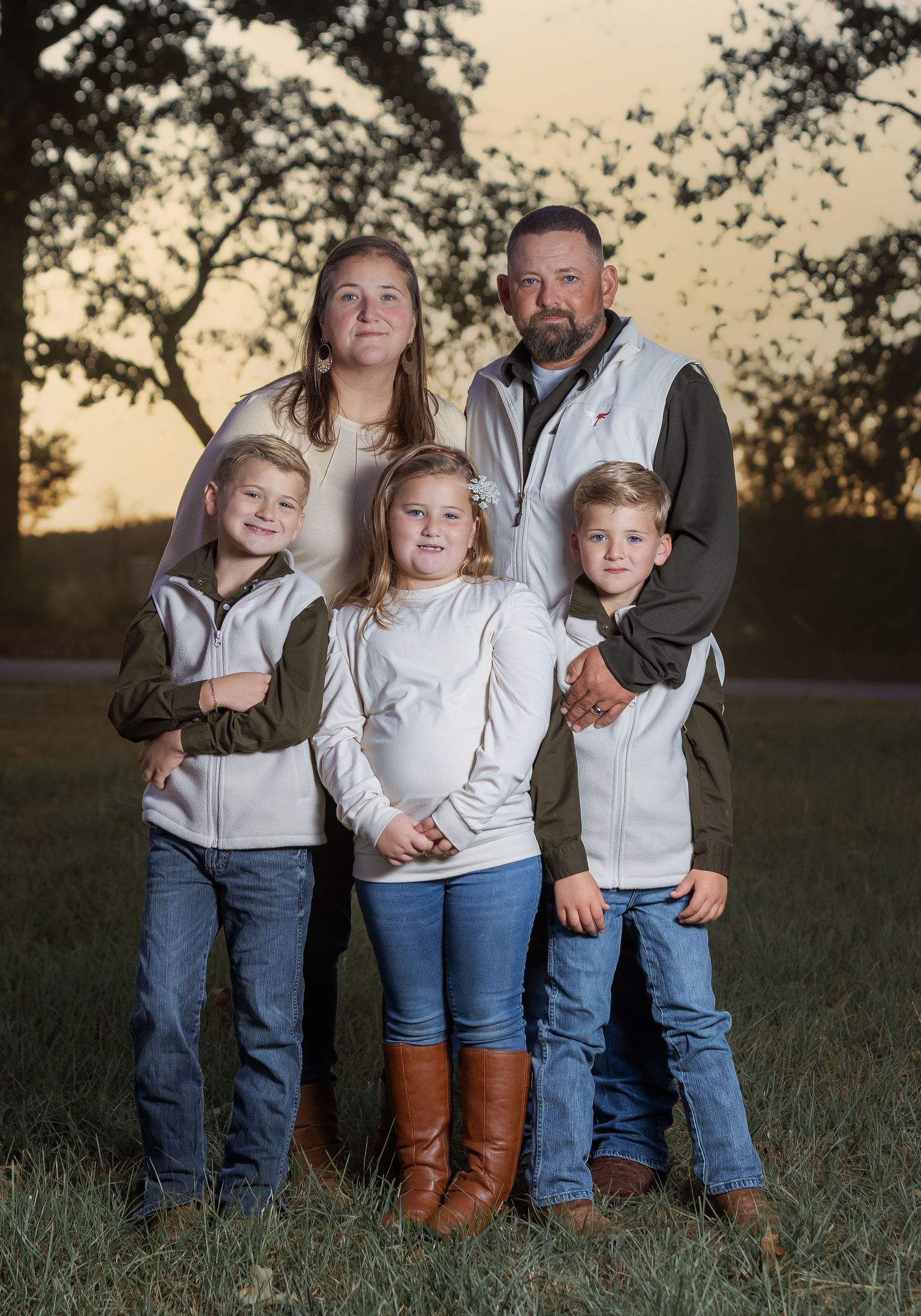 Lincoln, Alabama family photographer capturing portraits in a natural field at sunset.