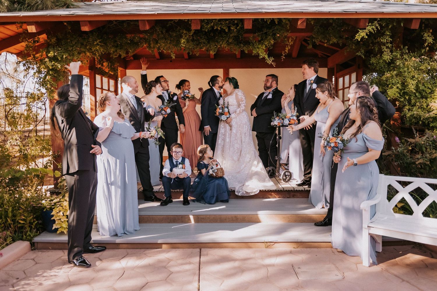 A wedding party gathers around a decorated gazebo. Small weddings in New Mexico. Intimate wedding venues. Albuquerque Garden Center weddings