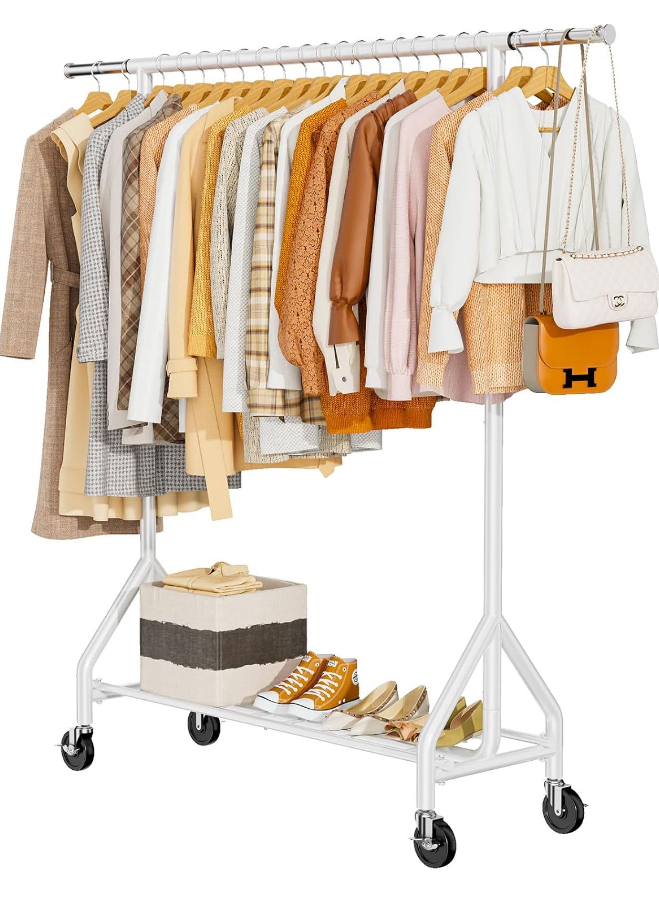 White metal clothing rack on wheels with beige and neutral colored garments and shoes organized on hanging rod and bottom shelf.