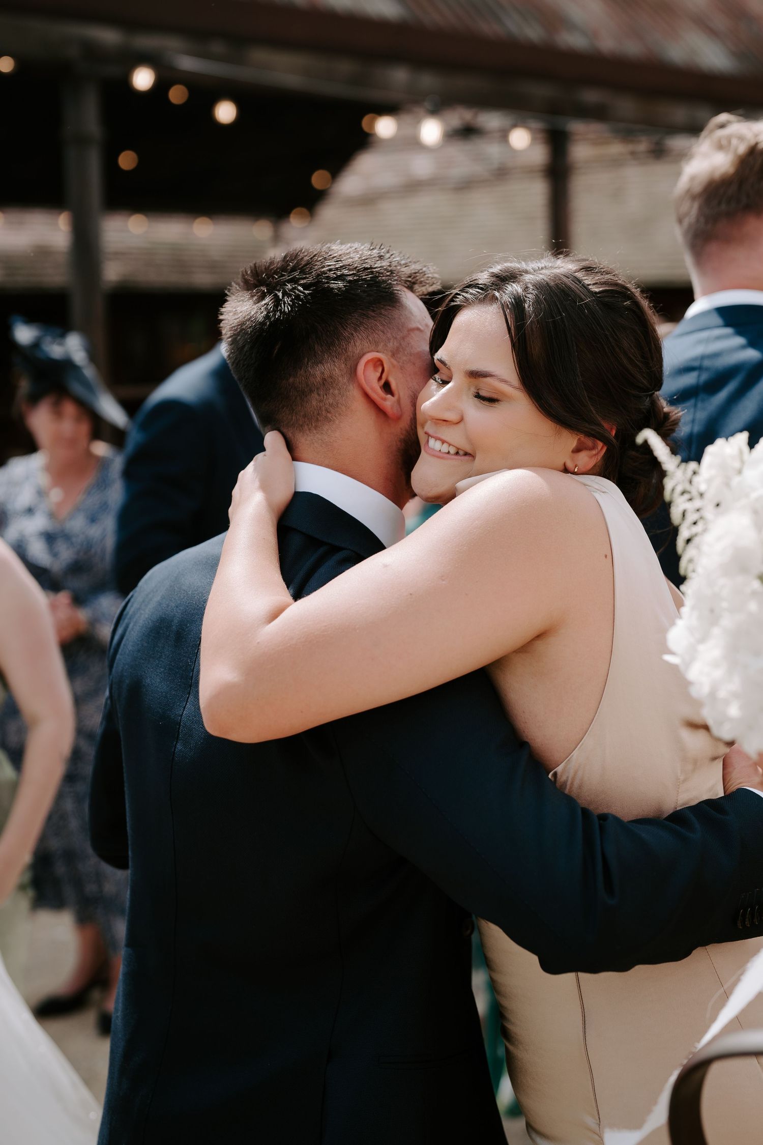 groom hugging sister at yardspace old gore in cirencester