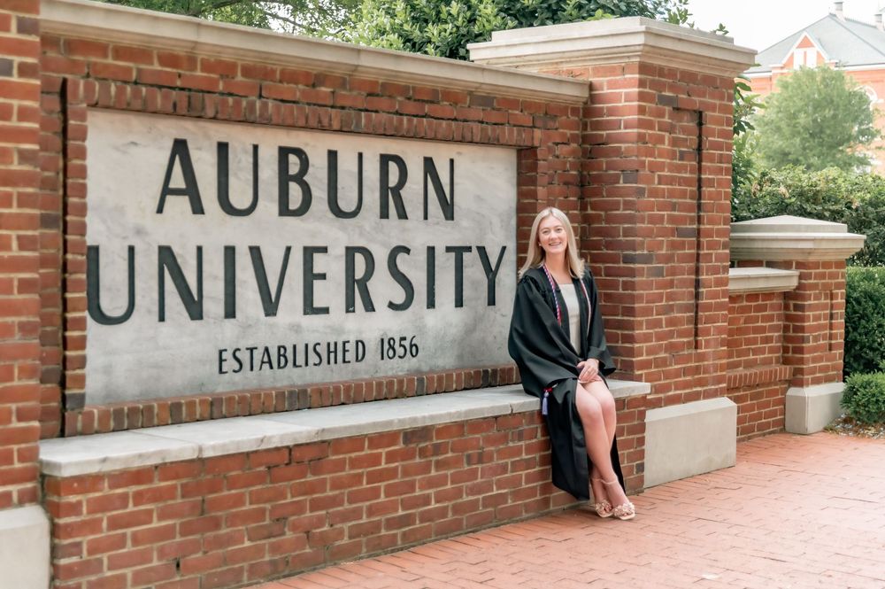 Historic Auburn University entrance sign with brick wall and established date.