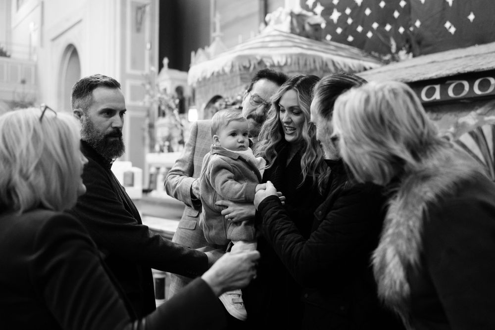 Black and white outdoor gathering with people interacting on a winter evening.