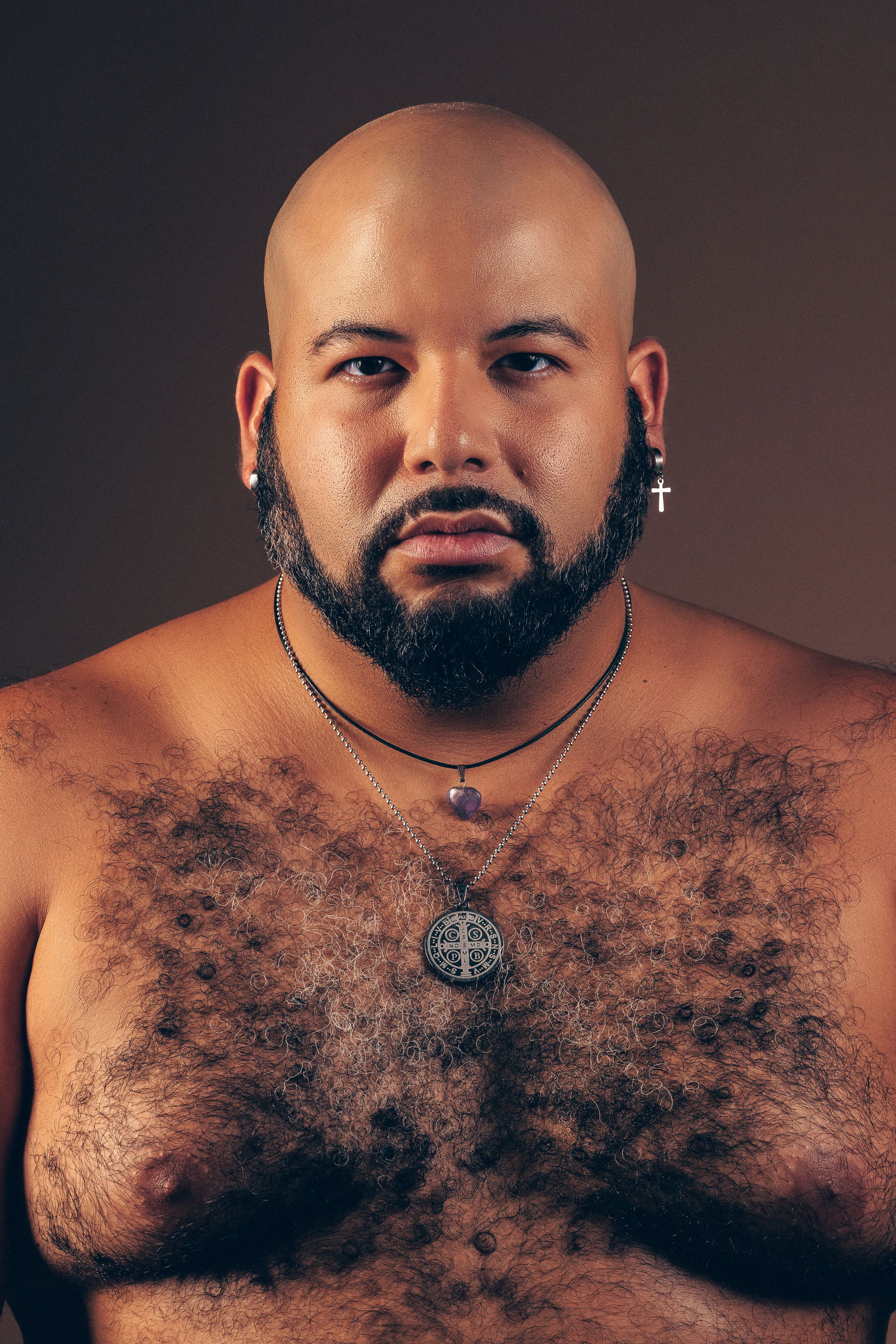 Sequential photos of a shirtless person with a beard and necklace against dark backdrop.