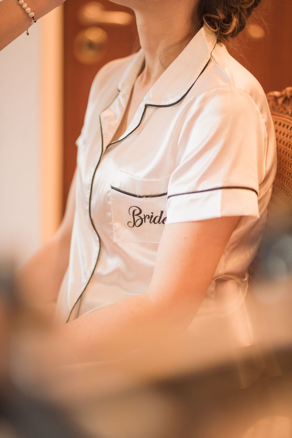 White silk bridal robe with black piping and 'Bride' embroidery detail.
