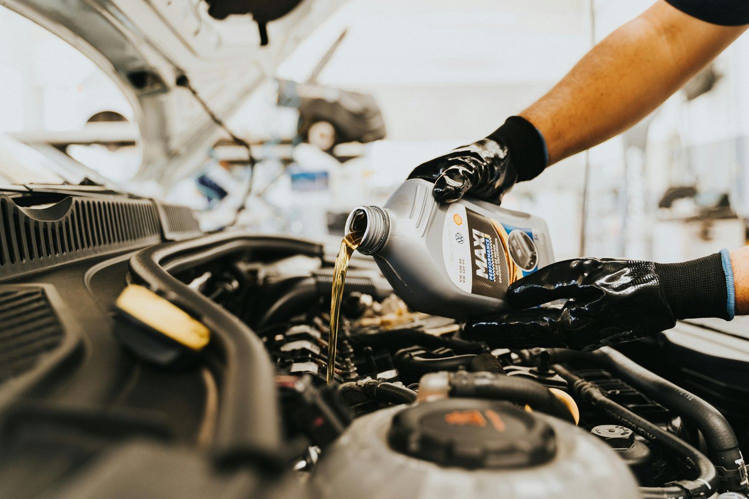 Pouring engine oil during an oil change service