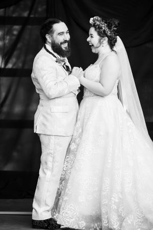 A joyful black and white wedding portrait capturing a candid laughing moment.