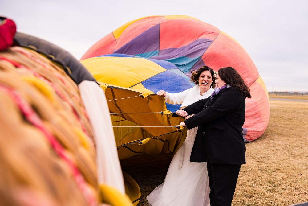A collection of images showing a hot air balloon landing and being deflated in an open field at sunset.
