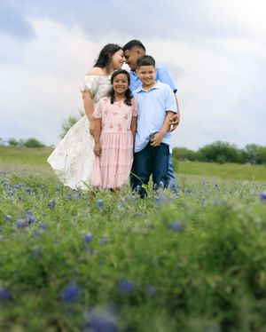 Adorable portrait of the family while mom and dad put their heads together.