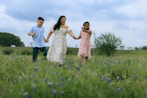 Mommy and me running across the blue bonnet field.