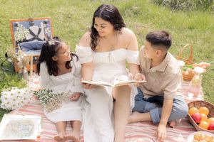 Mommy reading to her little ducklings during picnic time.