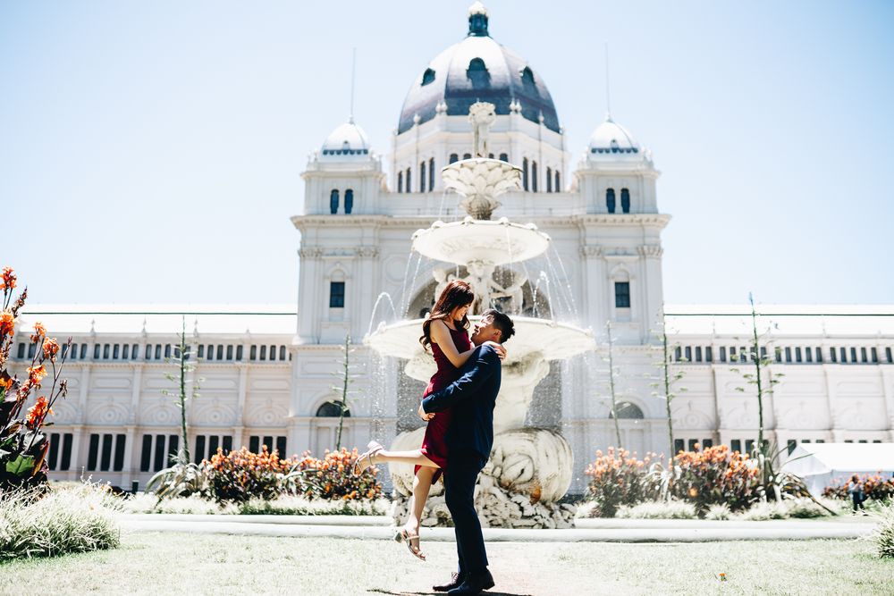 A couple embraces in front of the Royal Exhibition Building in Melbourne taken by Melbourne couples photographer