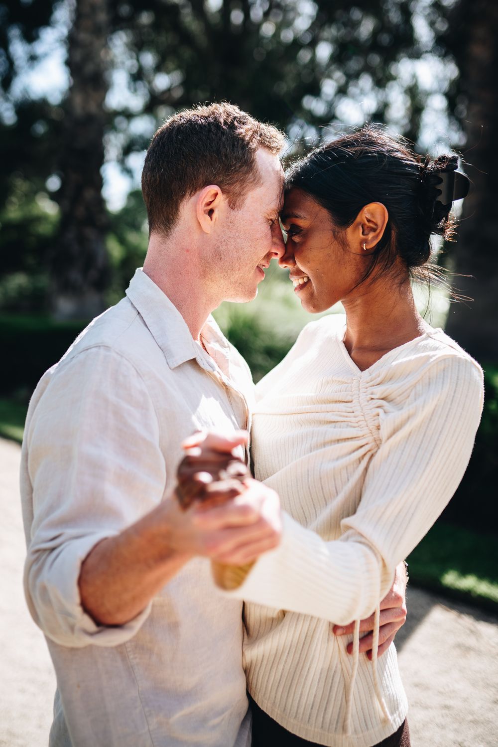 A newly engaged couple embracing together taken by a Melbourne couples and proposals photographer.