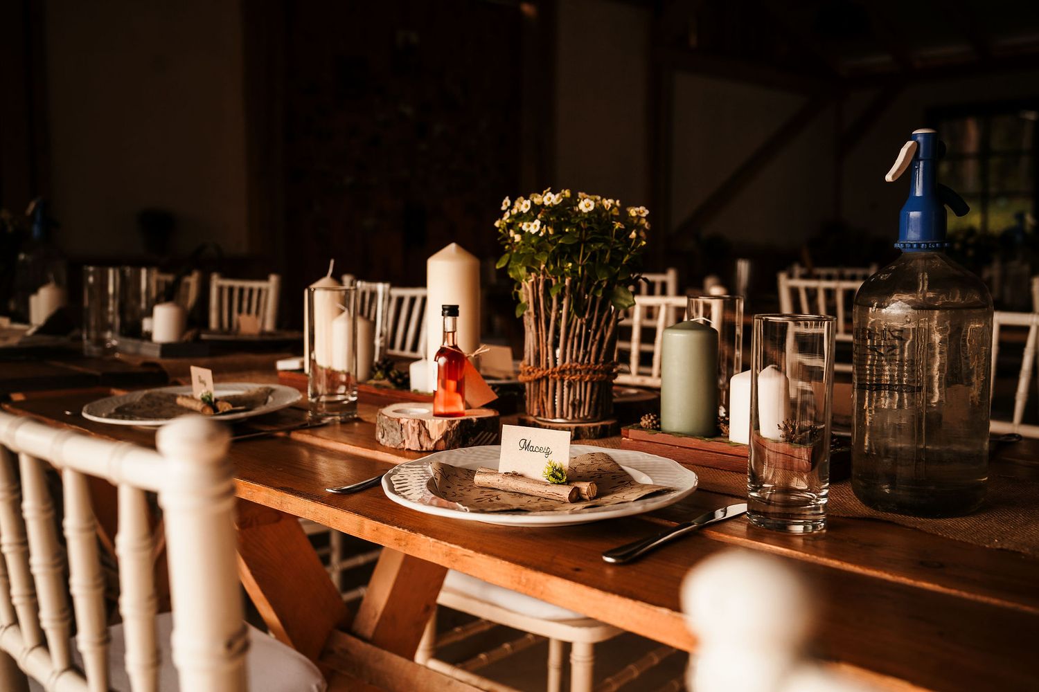 Elegant rustic wedding table setting with floral centerpieces and wooden details.
