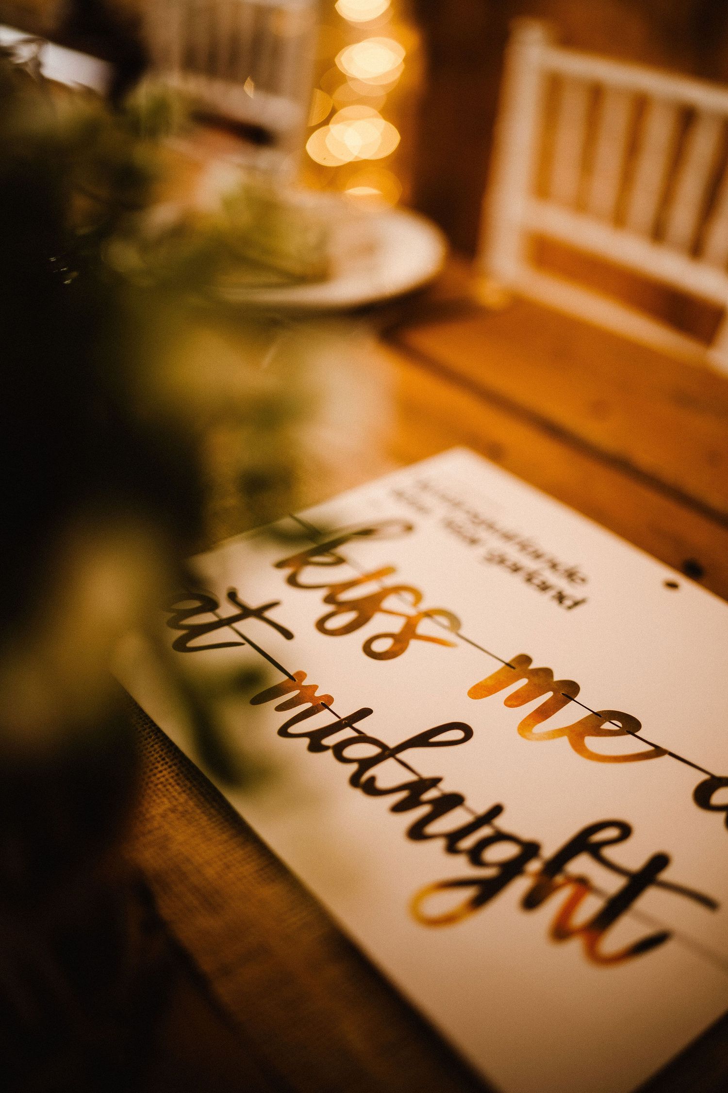 Wedding signage with gold and black calligraphy text on white background.