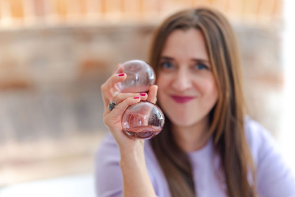 headshot of creative business woman holding sandtimer for personal branding in Kent