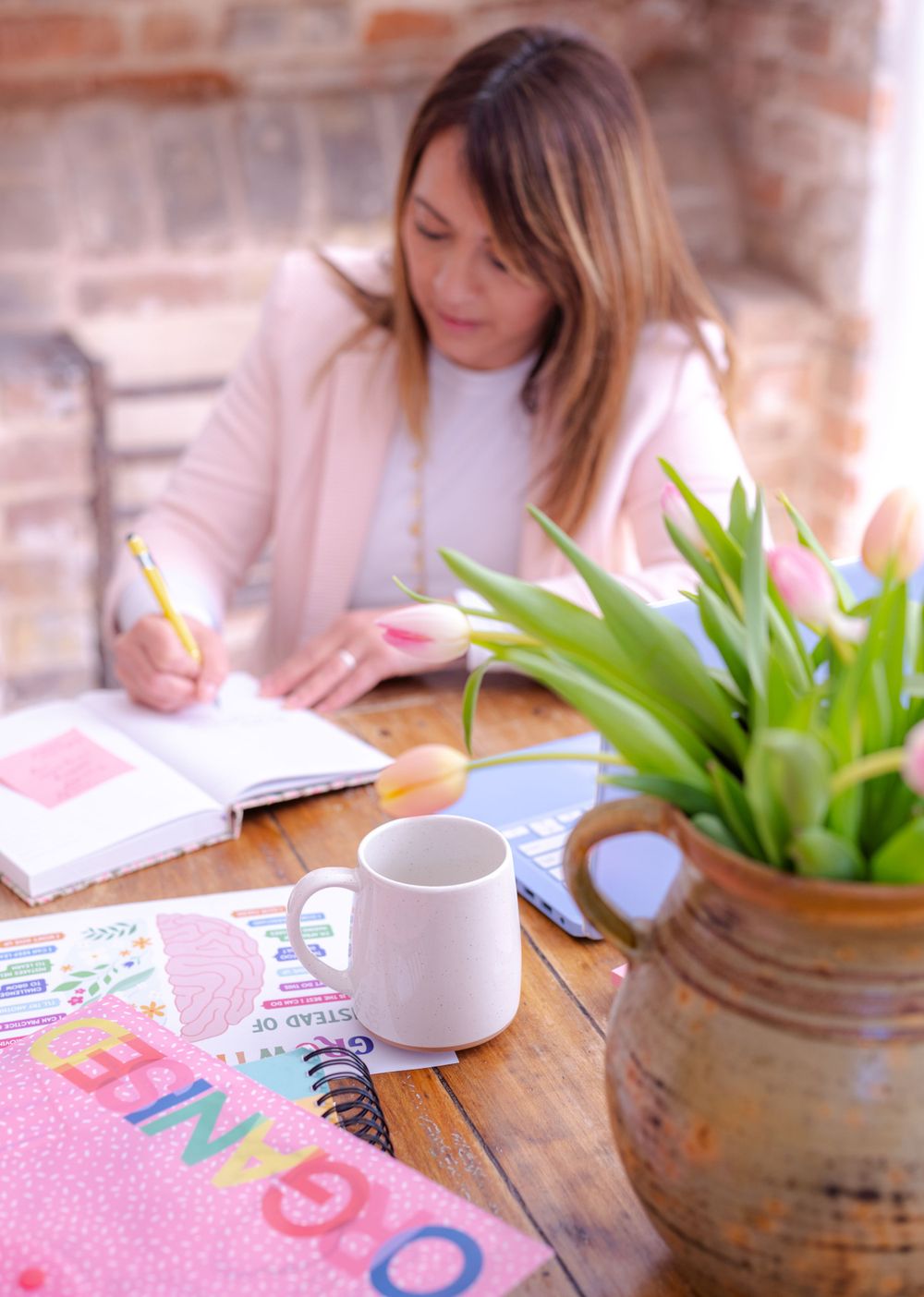 person working at table with flowers for personal branding headshot