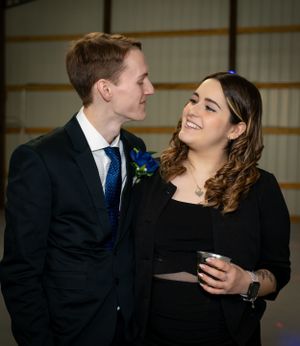 A couple shares an intimate moment together during a formal event.