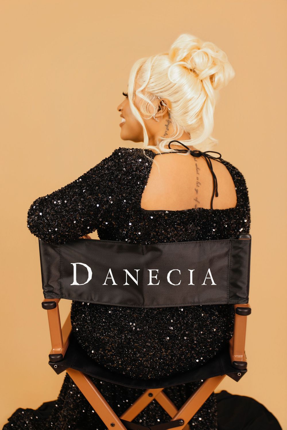 Director's chair with 'D'ANECIA' text shown from different angles against beige background.