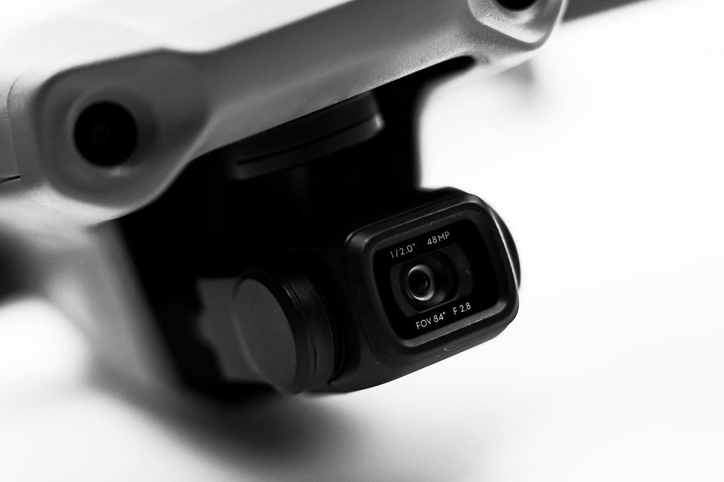 Close-up of DJI Mavic Air 2 camera gimbal system in monochrome.